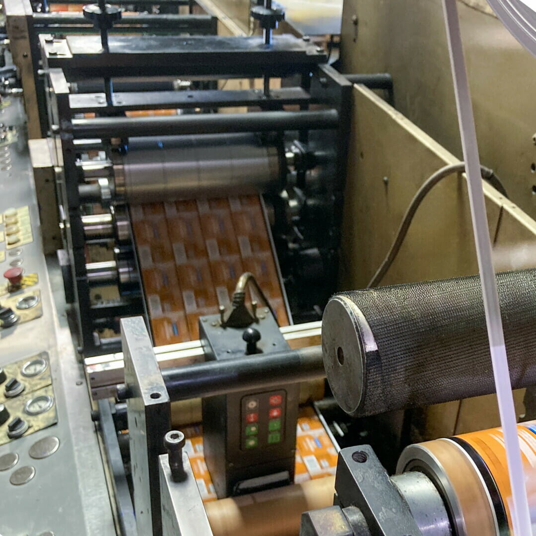 image of a high-end flexographic printing machine that is printing food container labels